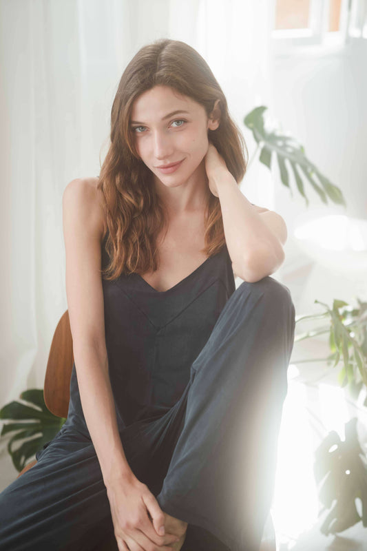 Model wearing SLATE BLACK WIDE JUMPSUIT, showcasing adjustable straps and effortless summer style.