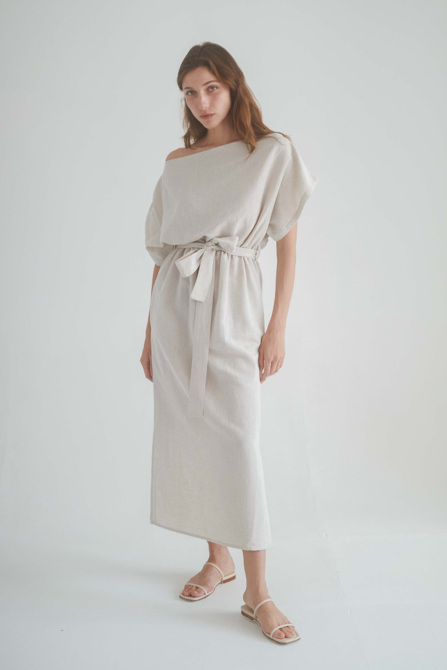 Natural drape dress with off-shoulder neckline and elasticated waist, showcasing a chic and casual style.
