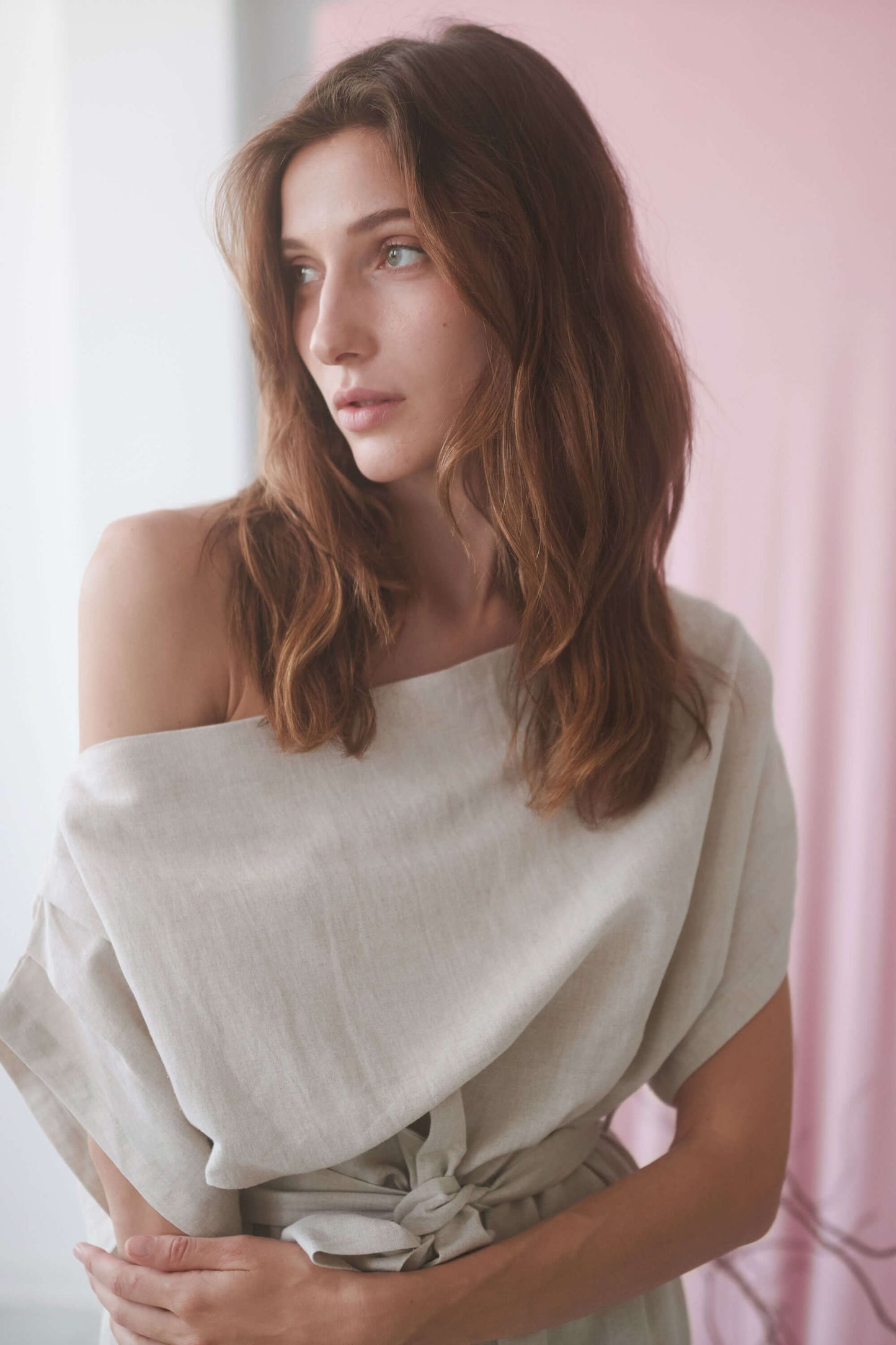 Model wearing a natural drape dress with an off-shoulder neckline, highlighting elegant style and comfort.