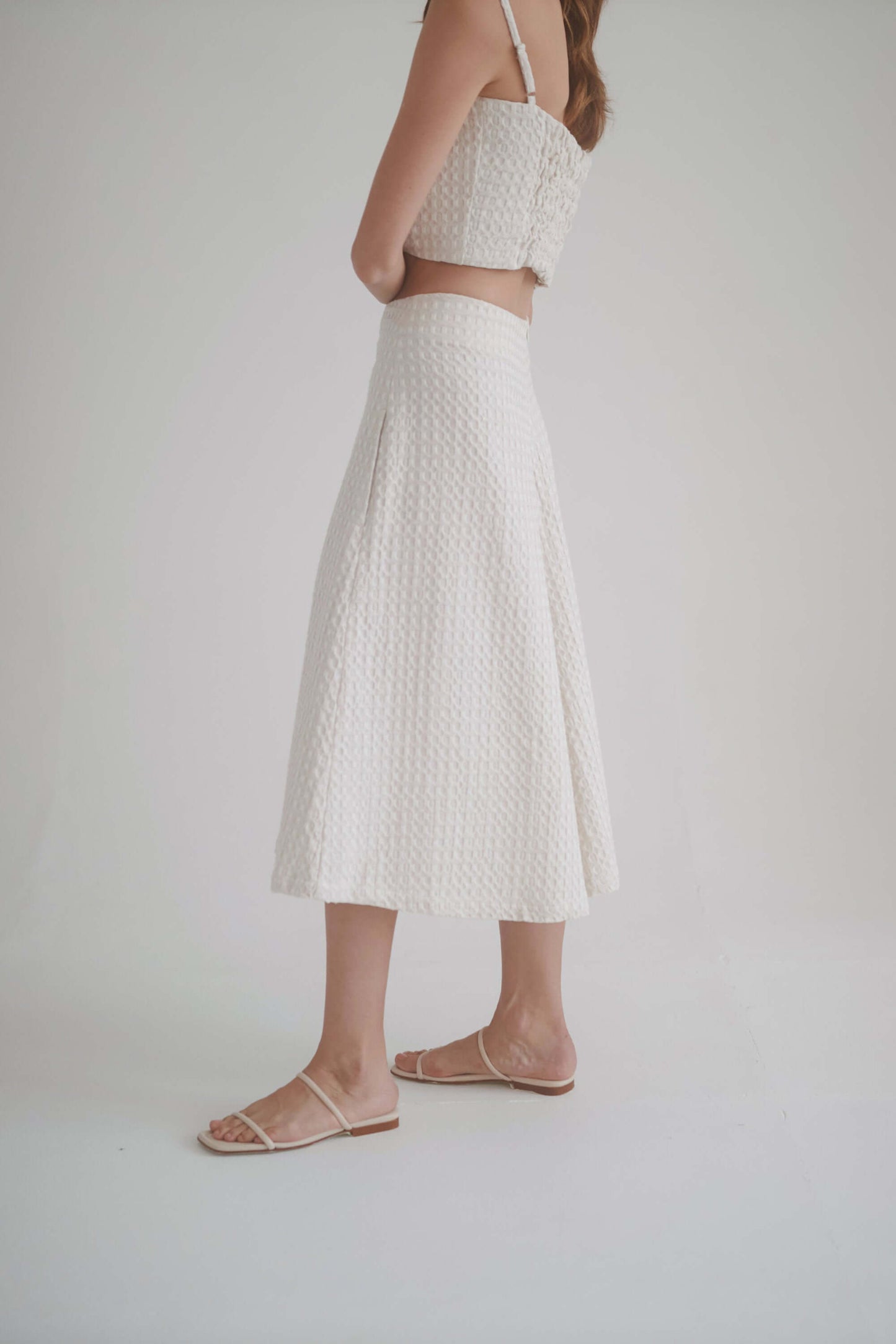 Model wearing ecru waffle culottes showcasing high waist and elegant A-line silhouette.