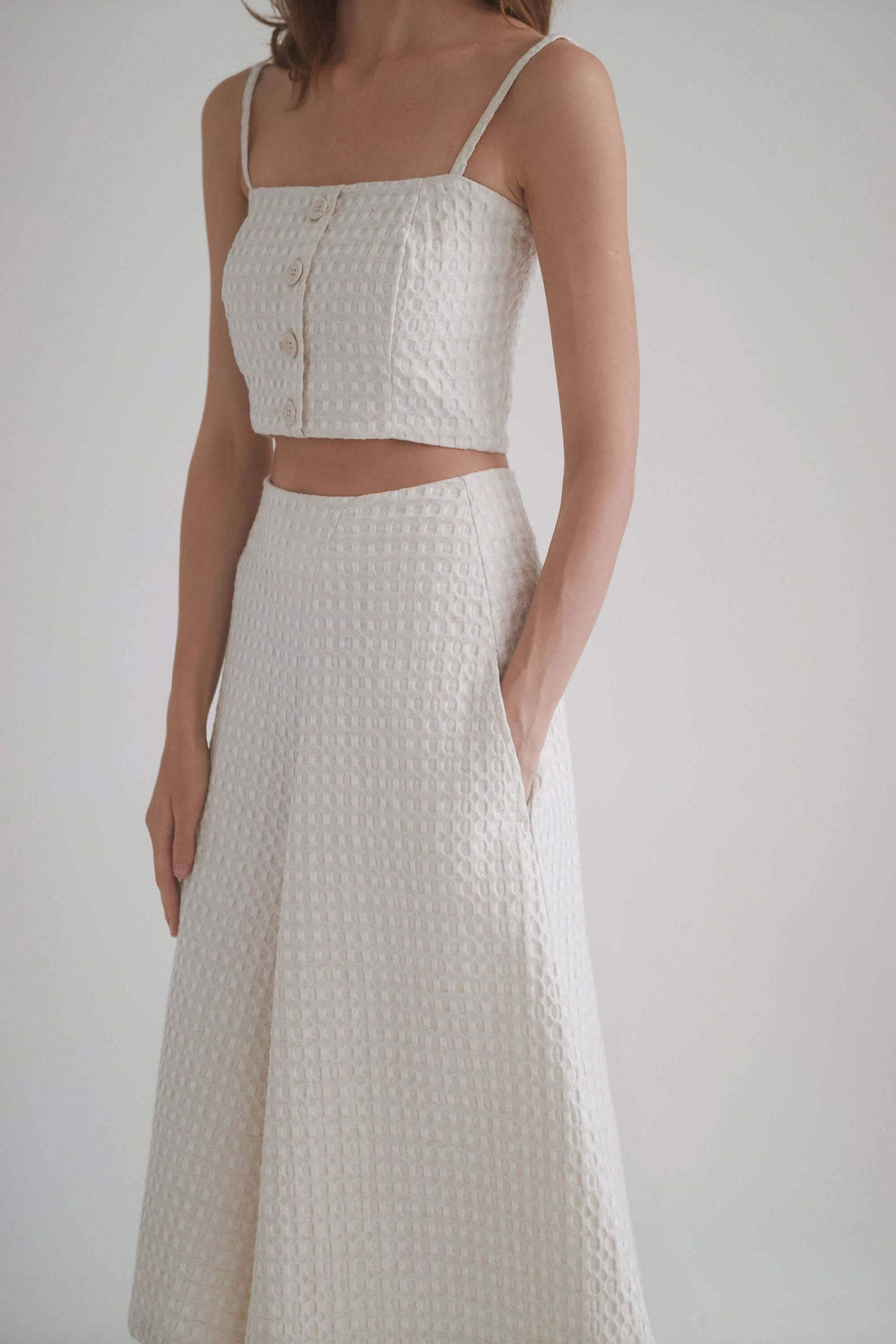 Ecru waffle culottes paired with matching crop top, showcasing high waist and side pockets, ideal for stylish comfort.