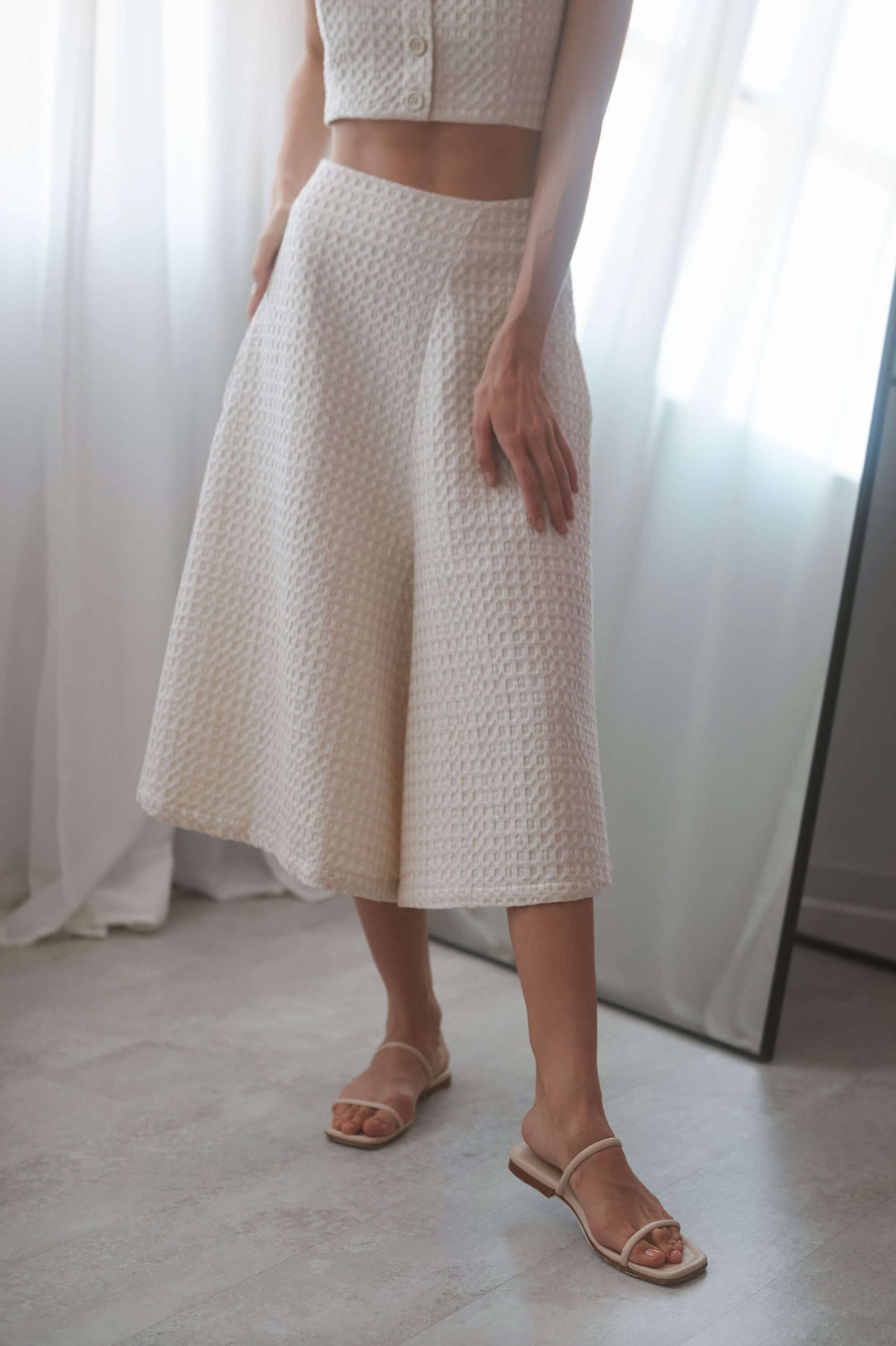 Ecru waffle skirt culottes with a high waist, side pockets, and a stylish A-line silhouette, perfect for versatile outfits.
