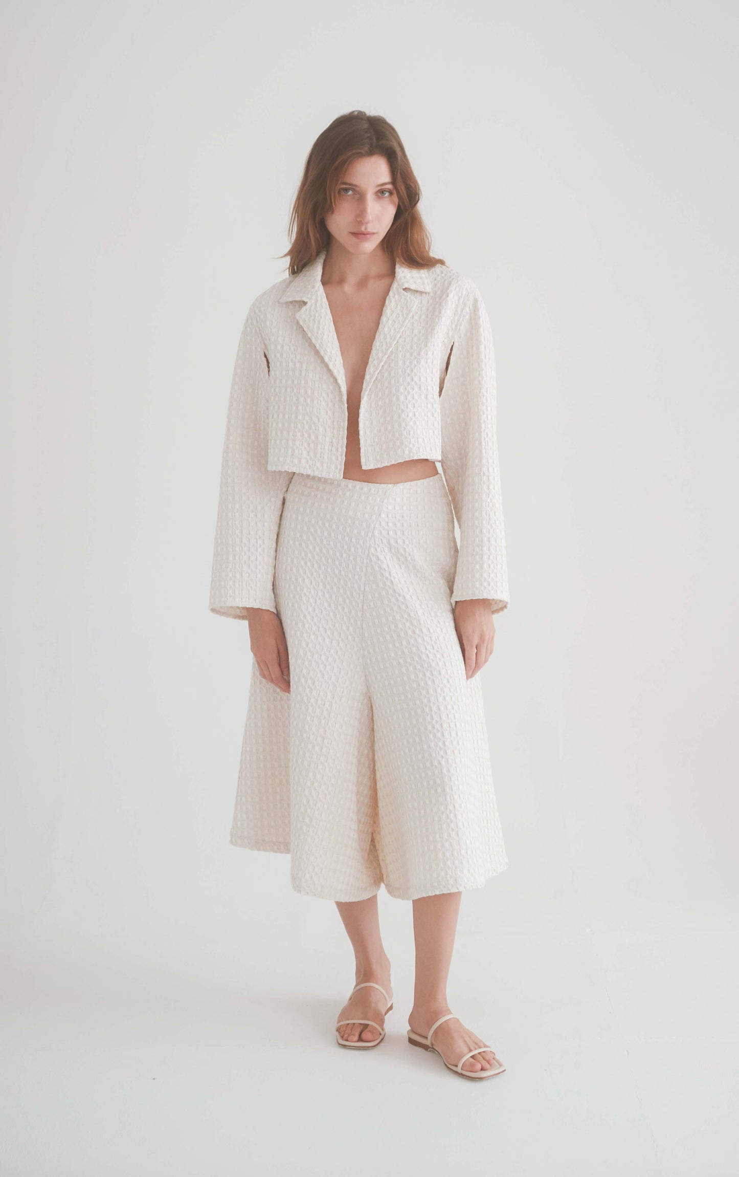 Ecru waffle skirt culottes paired with matching cropped jacket, showcasing sustainable fashion and versatile styling options.