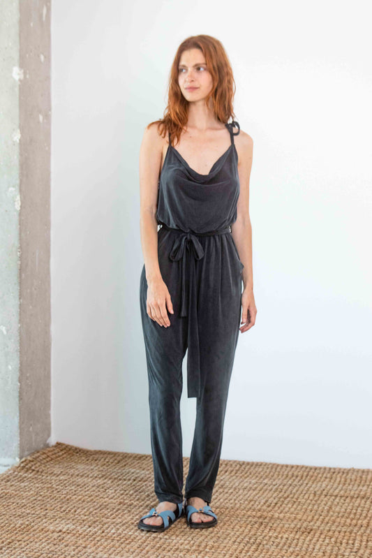 Cupro Slip Jumpsuit with Belt in Slate Black worn by a model, showcasing its relaxed and elegant fit.