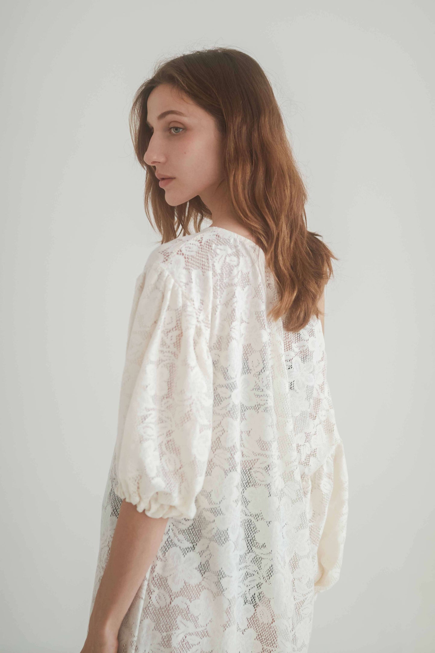 Elegant model wearing a Lace Boho Maxi Dress, showcasing its balloon sleeves and organic cotton lace design.