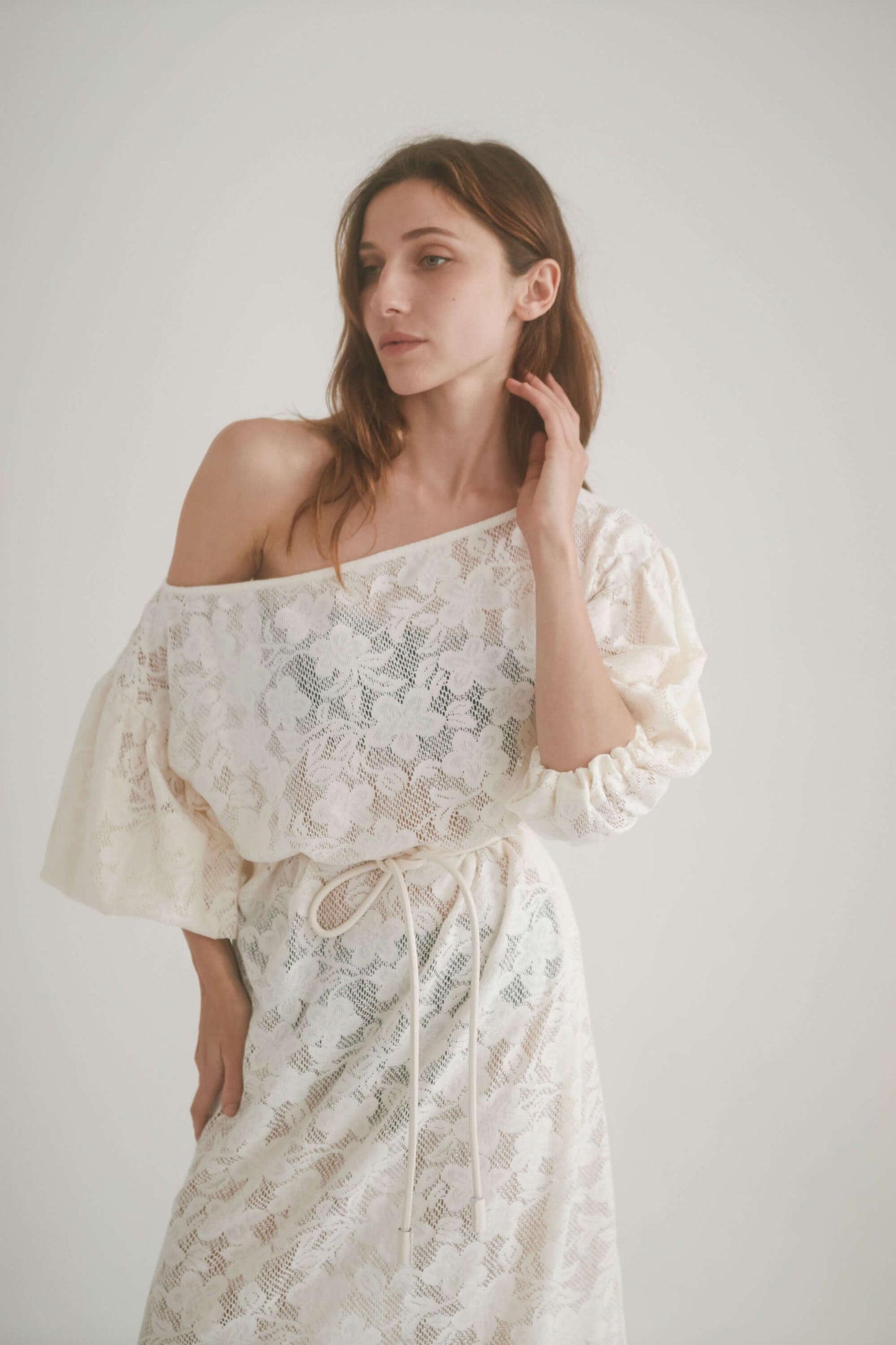 Model wearing a lace boho maxi dress with balloon sleeves and a waist tie, showcasing its elegant design.