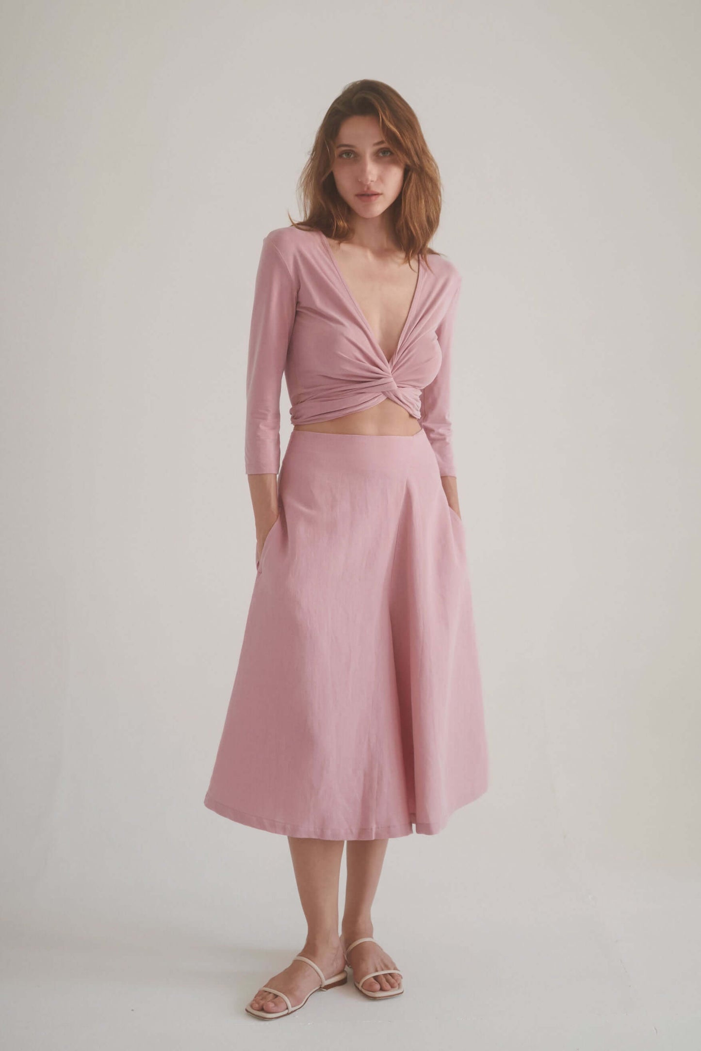 Model wearing rose skirt culottes with a matching rose wrap top, showcasing elegance and comfort in sustainable fabric.