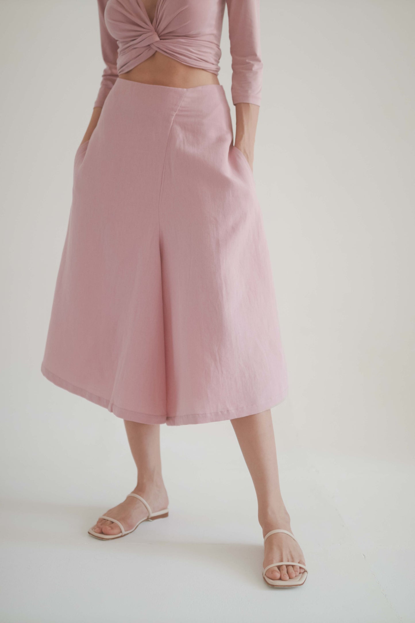 Rose skirt culottes, high-waisted, featuring side pockets, paired with a wrap top for elegance and comfort.