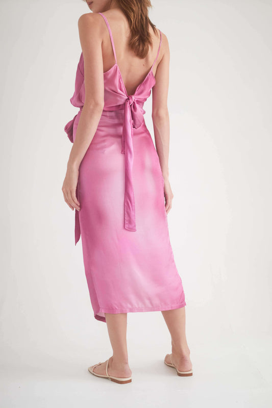 Back view of a model in a pink wrap midi dress with self-tie closure, showcasing style and comfort.