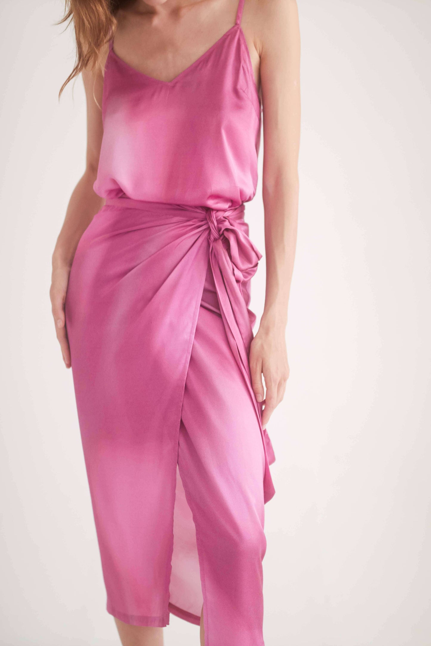 Model wearing a pink printed wrap midi skirt with self-tie closure, showcasing comfort and versatile styling.