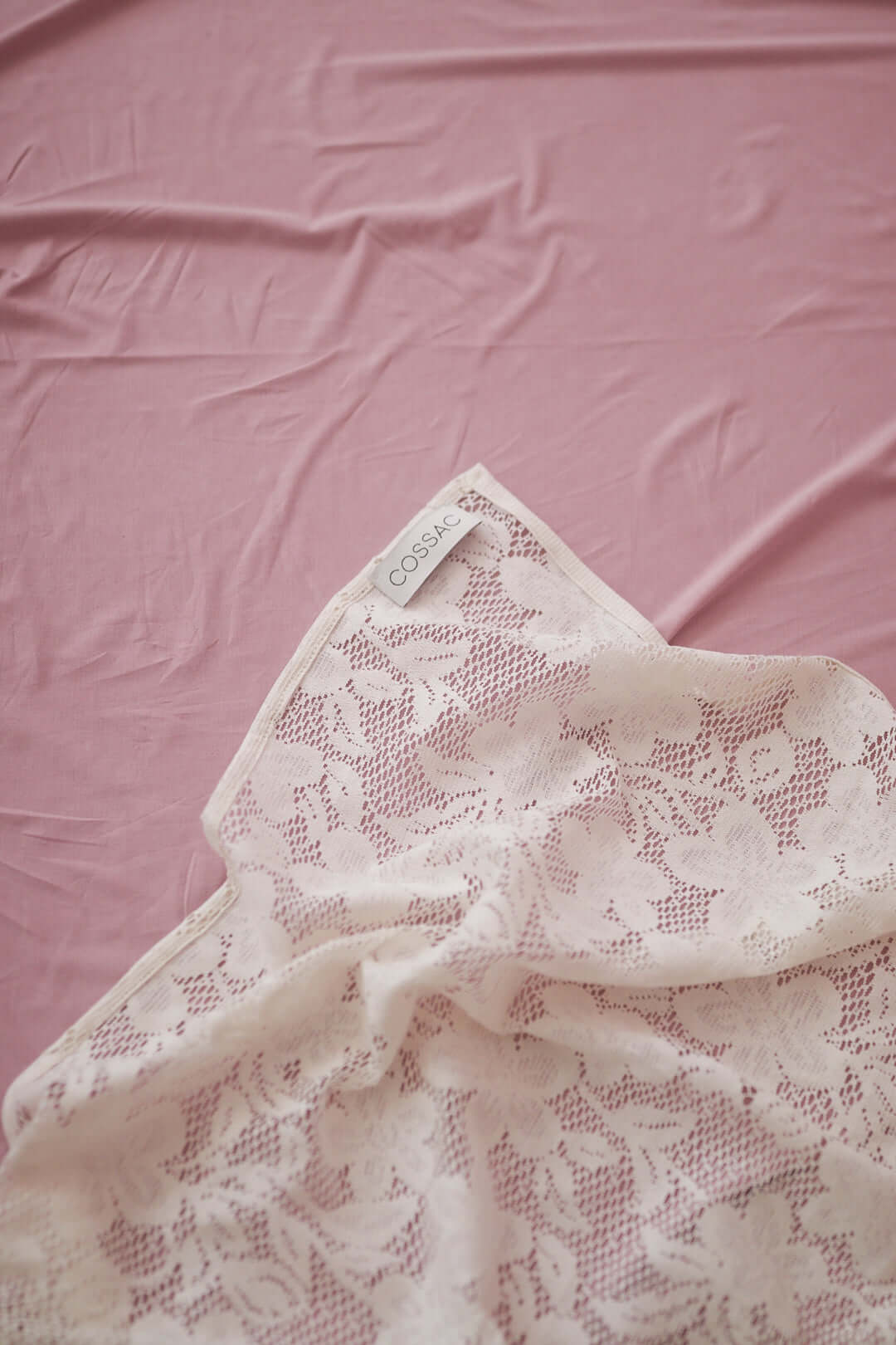Small lace scarf in ecru on a pink background, made from 100% organic cotton knitted lace, online exclusive.