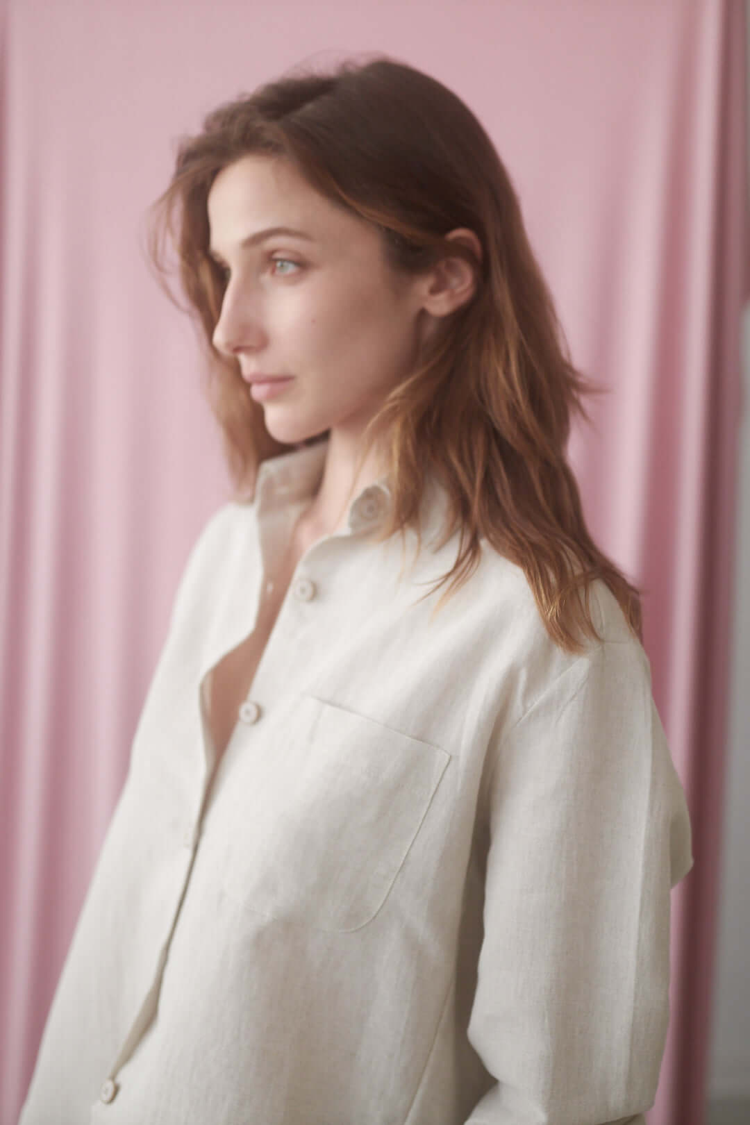Model wearing the Natural Wide Shirt made from organic cotton and linen, showcasing an oversized fit against a pink background.