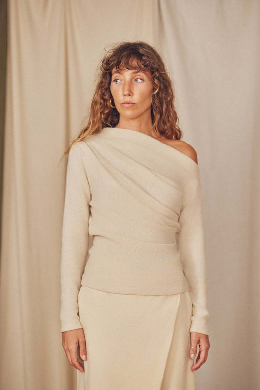 Oat Wool Fine Knit Drape Top with soft neckline and thumb holes, perfect for layering in colder seasons.