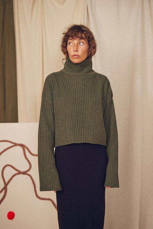Model wearing a Khaki Heavy Knitted Wool Sweater with a turtleneck and ribbed texture, styled for autumn layering.
