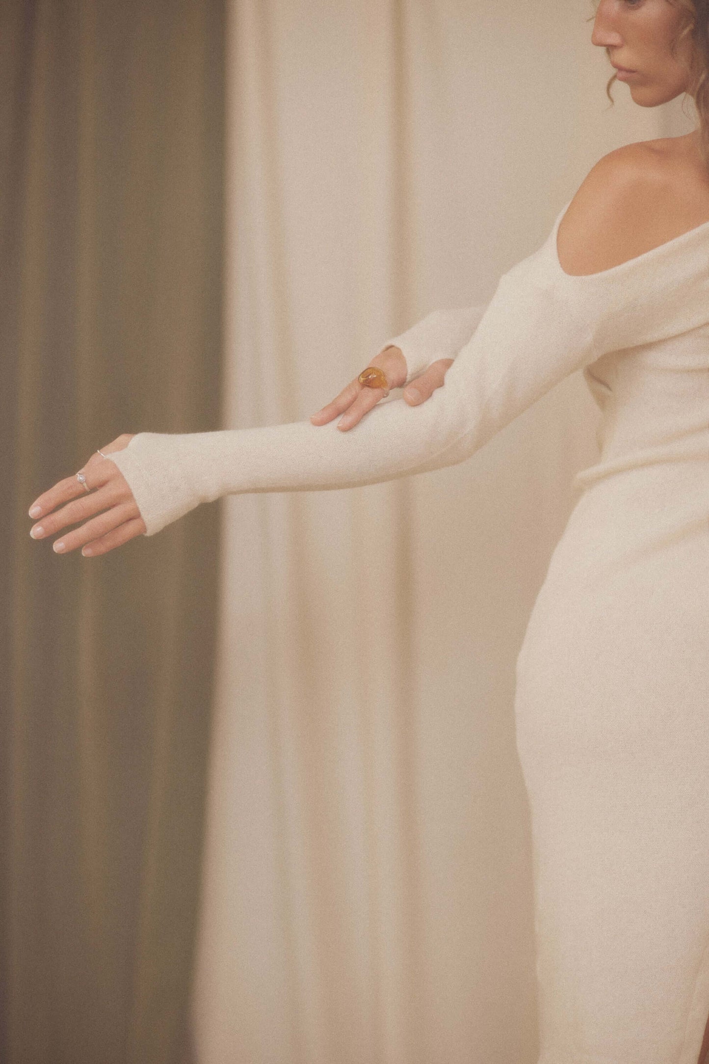 Model showcasing the Oat Fine Knit Drape Dress with a flattering drape neckline and long sleeves.