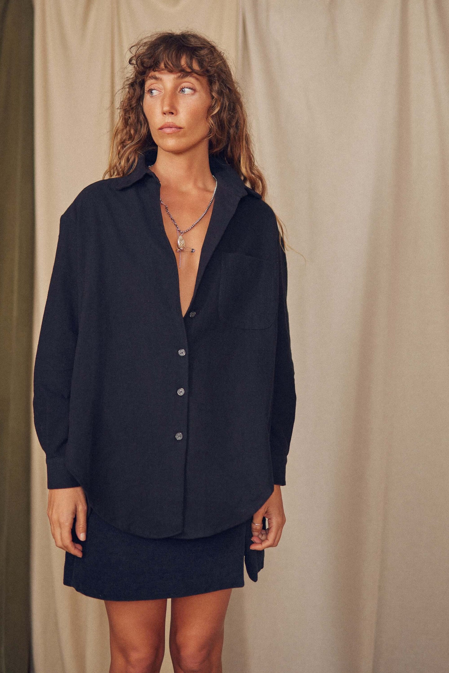 Model wearing a black organic cotton wide overshirt, perfect for autumn layering and sustainable fashion.