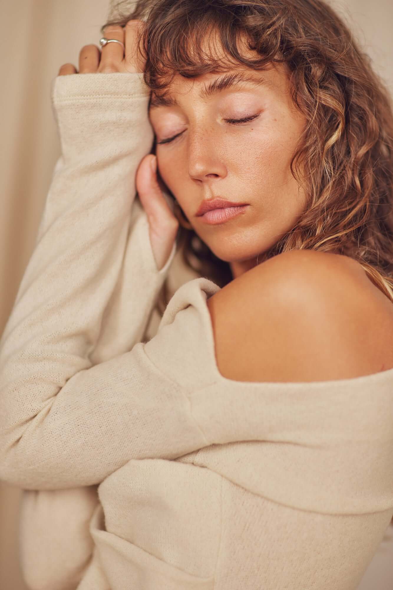 Model wearing Oat Wool Fine Knit Drape Top with soft drape neckline and thumb holes, showcasing a relaxed style.