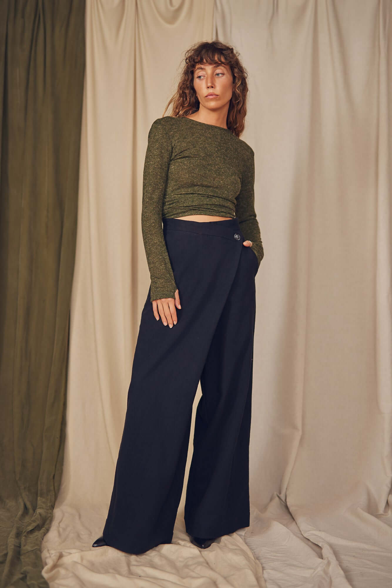 Woman wearing black wrap trousers.
