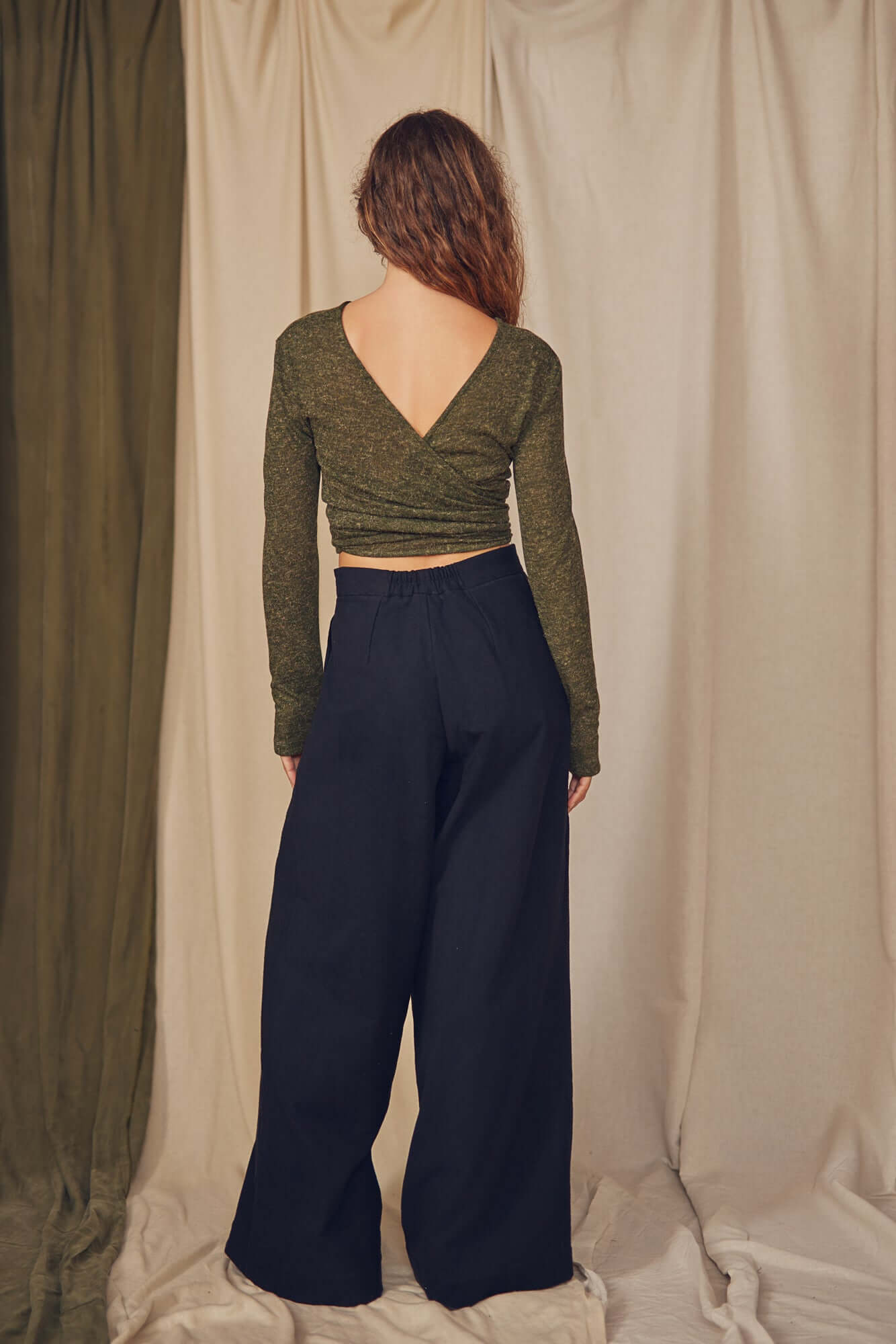 Woman wearing black wrap trousers.