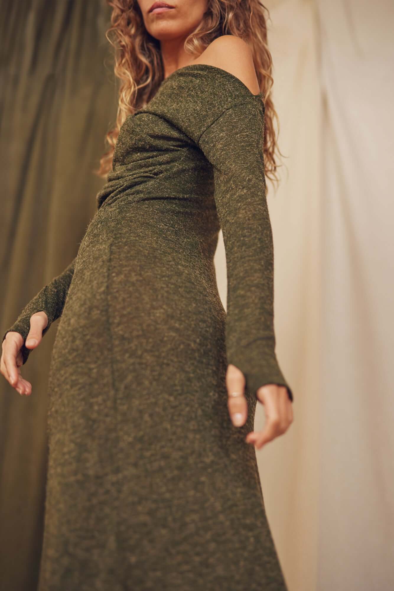 Model showcasing the Khaki Recycled Jersey Drape Midi Dress with off-shoulder design and thumb holes.