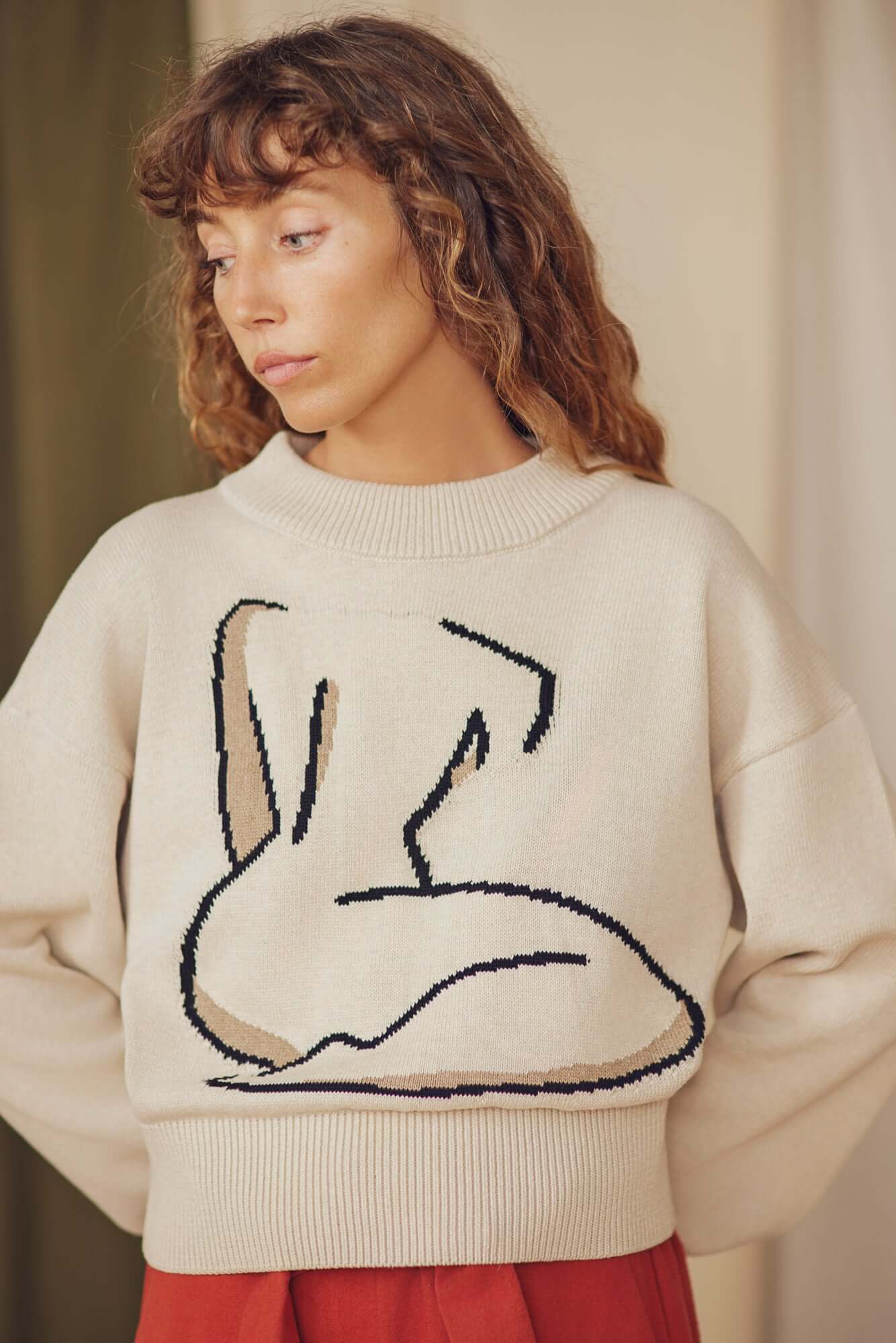 Jacquard Cotton Knit Sweater - ARCHIVE SALE on model with curly hair, featuring unique jacquard design.