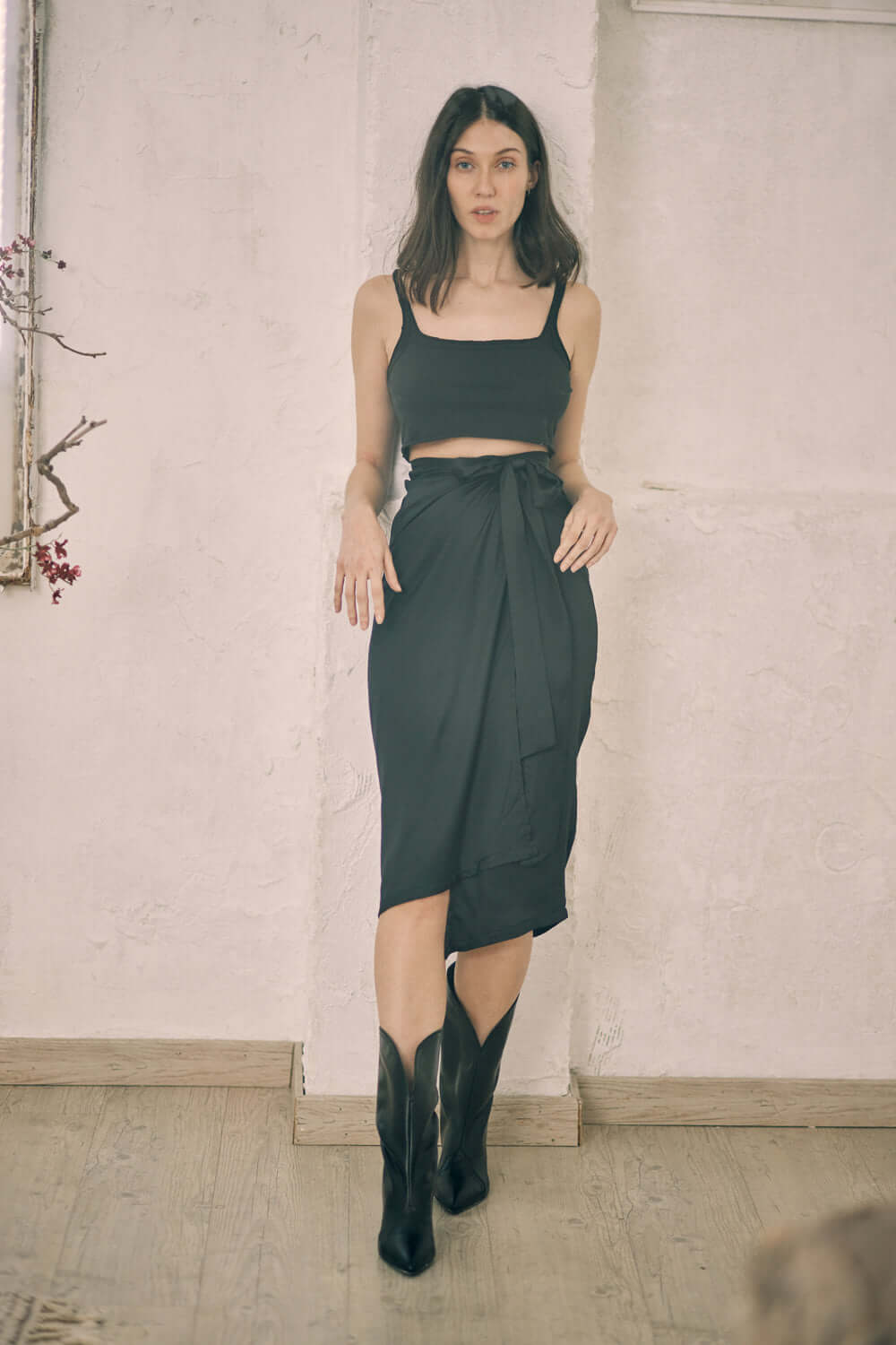 Black wrap midi skirt styled with a crop top, showcasing self-tie closure, model is 175cm, wearing size S.