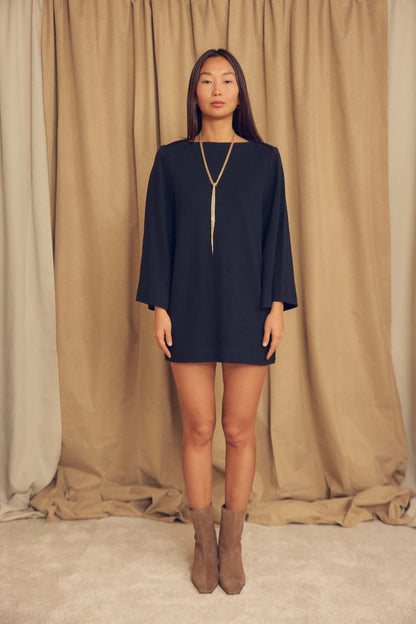 Black Organic Cotton Mini Dress with Flared Sleeves worn by a model, showcasing flared sleeves and a minimalist design.