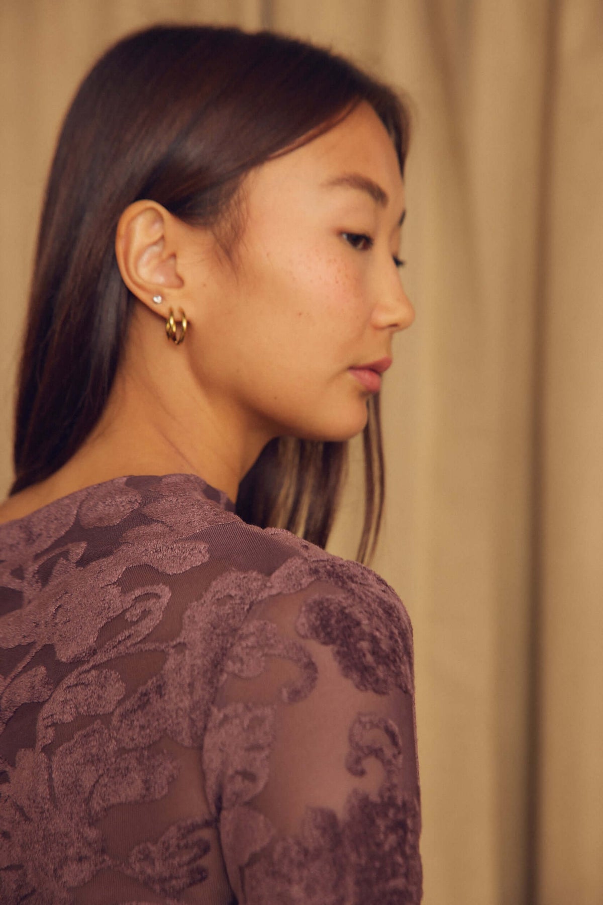 Cocoa Devoré Drape Top worn by a model, showcasing its unique abstract pattern and elegant draping design.