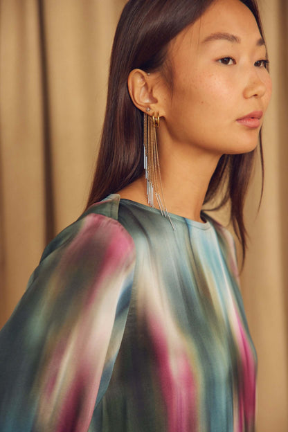 Close-up of a model wearing a Printed ECOVERO Viscose Mini Dress with Flared Sleeves and statement earrings.