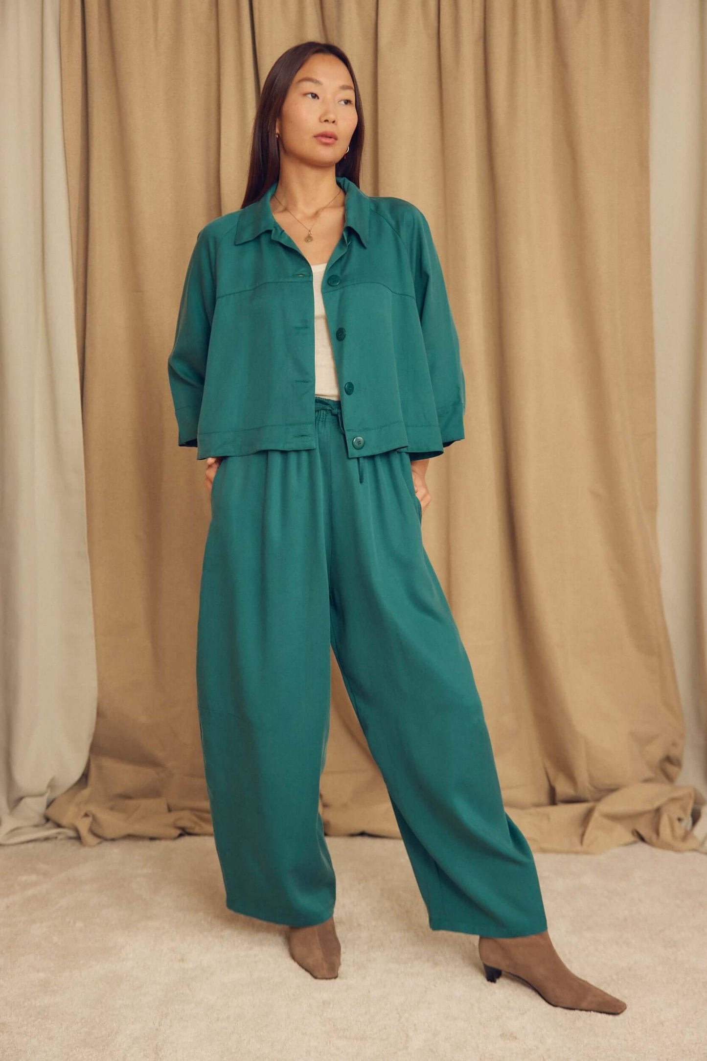 Teal Lyocell Barrel-Leg Trousers styled with a matching jacket, showcasing relaxed tailoring and an exaggerated silhouette.