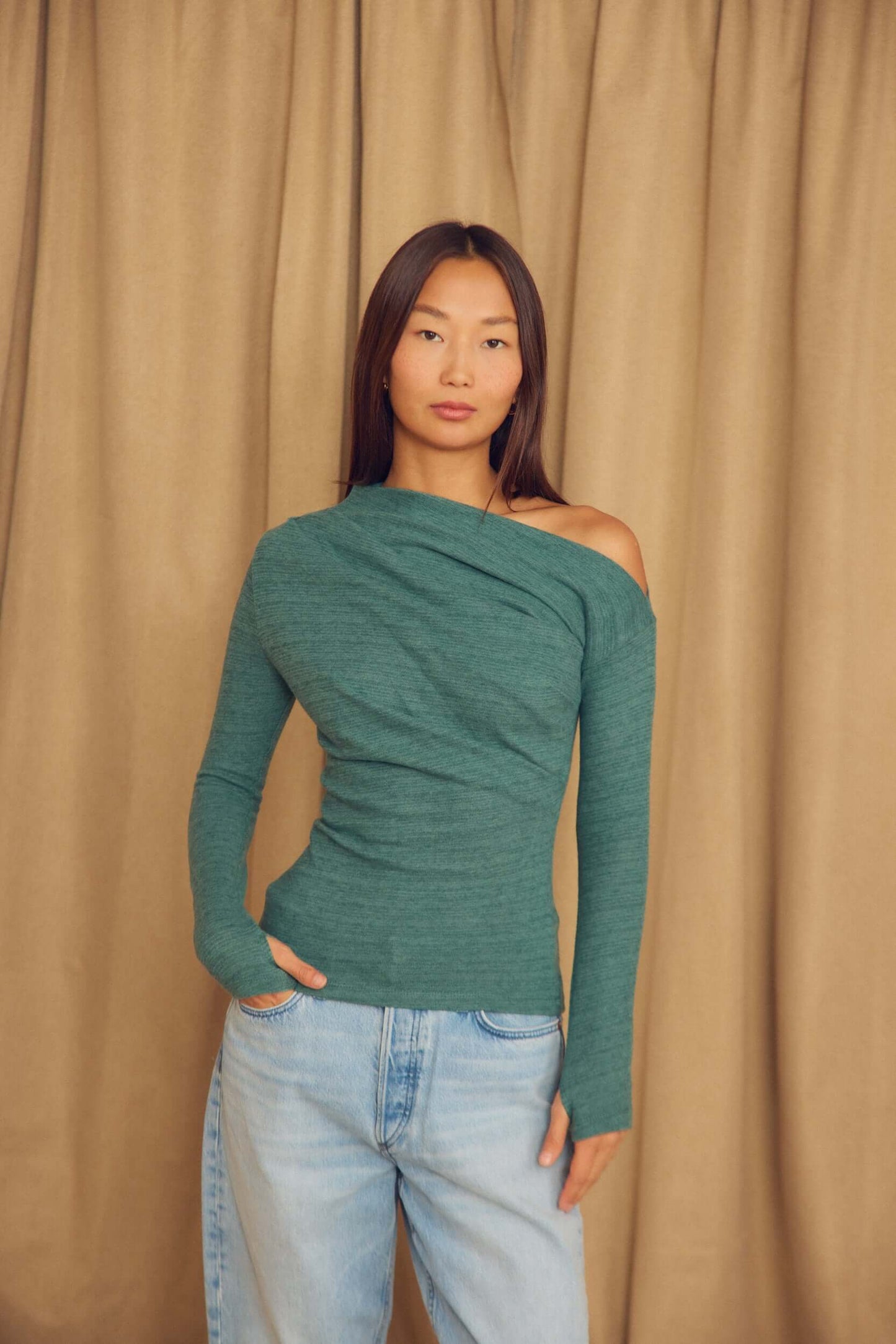 Teal Wool Drape Top with Thumb Holes worn by a model, featuring an elegant draped neckline and soft fit.