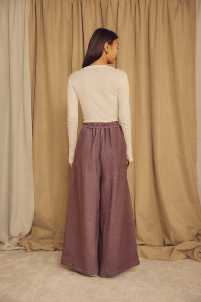Model wearing Cocoa Organic Cotton Wide Trousers from the back, showcasing the oversized, wide-leg silhouette.