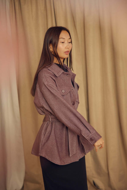 A model wearing the Cocoa Organic Cotton Shacket, featuring a relaxed silhouette and detachable waist tie.