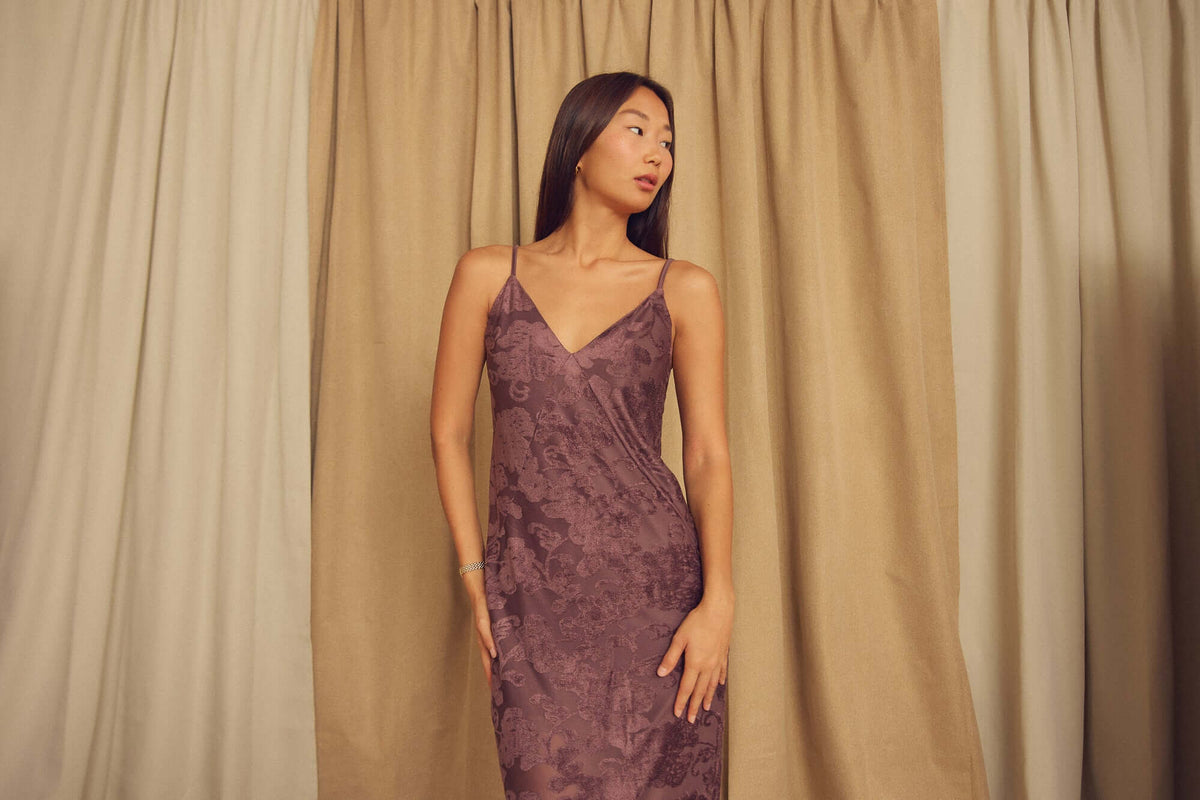 Model wearing Cocoa Devoré Strappy Midi Slip Dress, showcasing its abstract pattern and delicate straps.