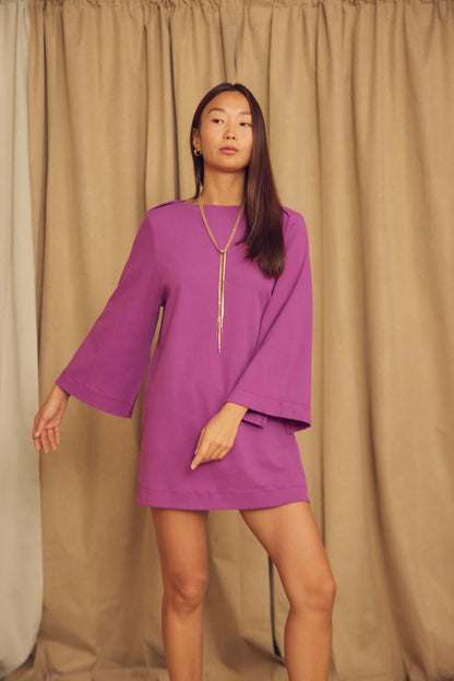 Model wearing a Plum Organic Cotton Mini Dress with Flared Sleeves in a studio setting.