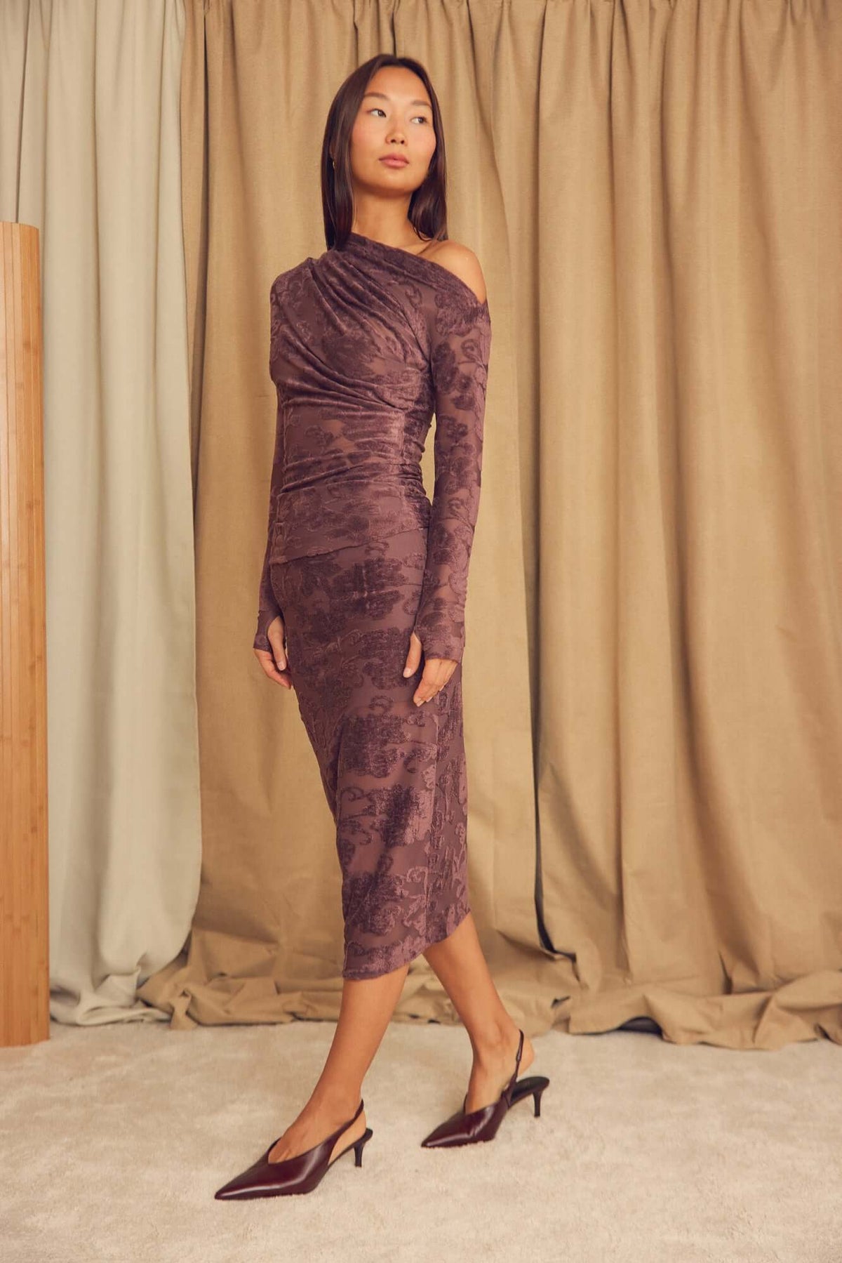 Model wearing the Cocoa Devoré Fitted Midi Skirt with a stylish design and textured fabric.