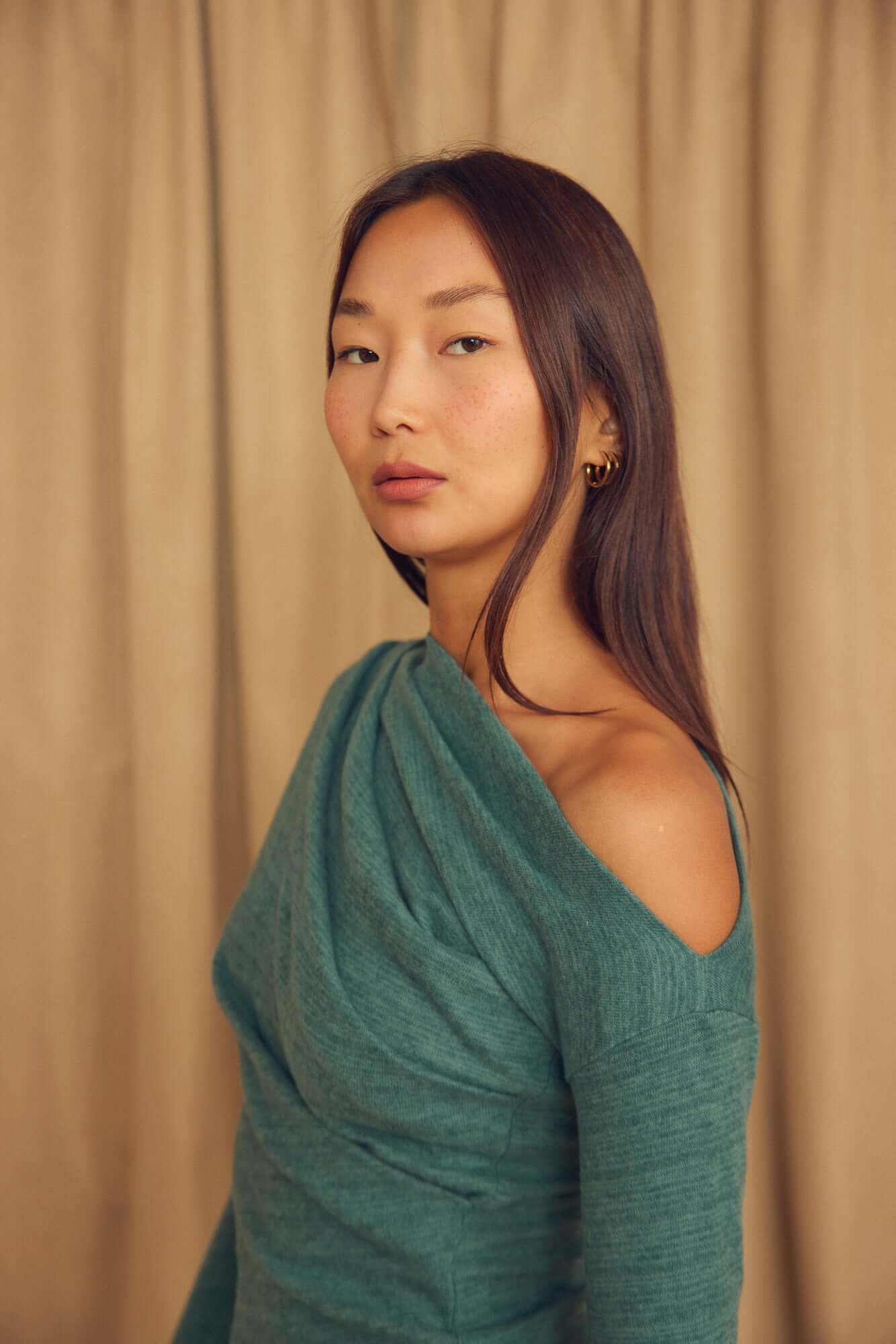 Model wearing a Teal Wool Drape Top with an elegant draped neckline, showcasing its soft and comfortable fit.