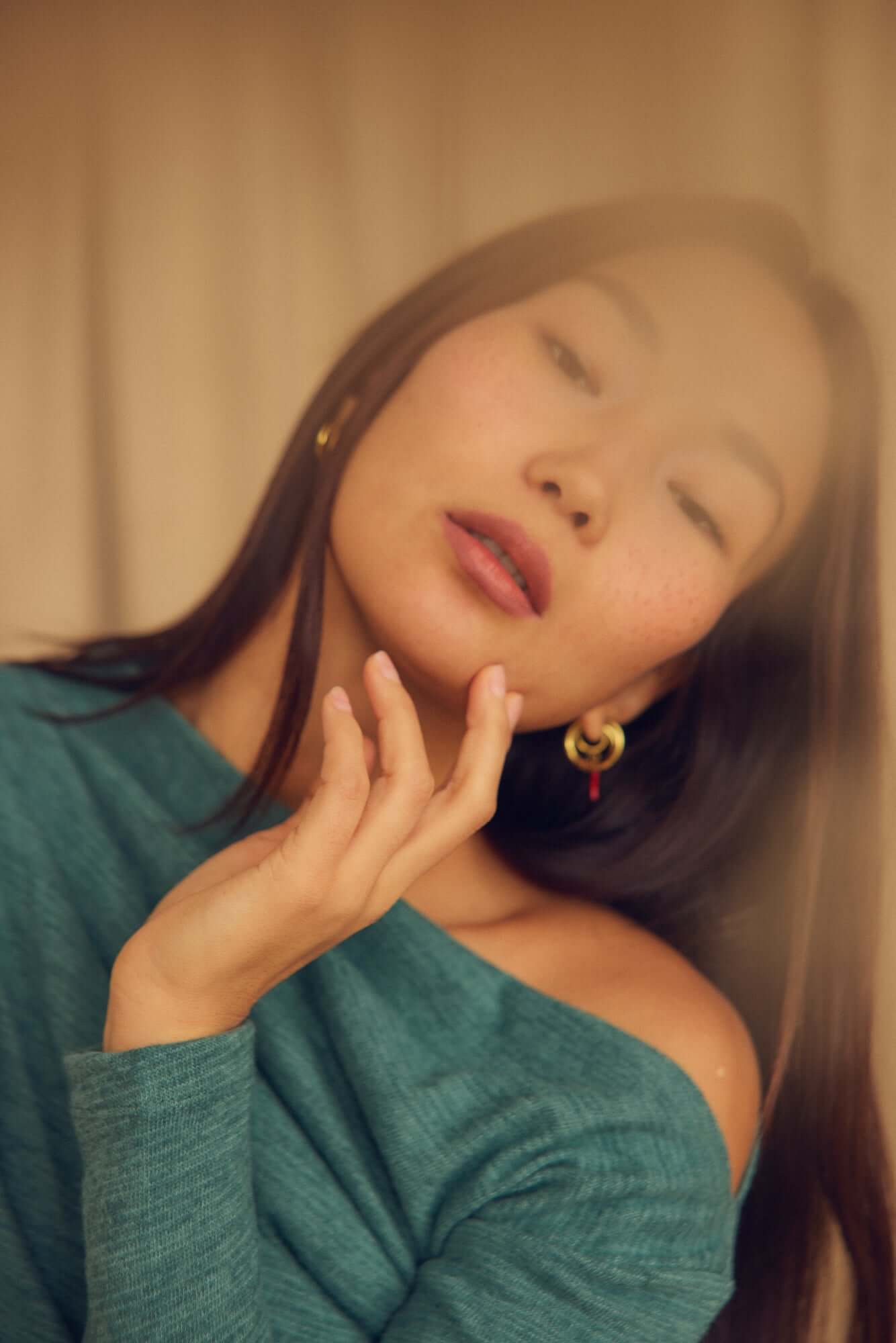 Model wearing a Teal Wool Drape Top with Thumb Holes, showcasing the elegant draped neckline and soft fit.