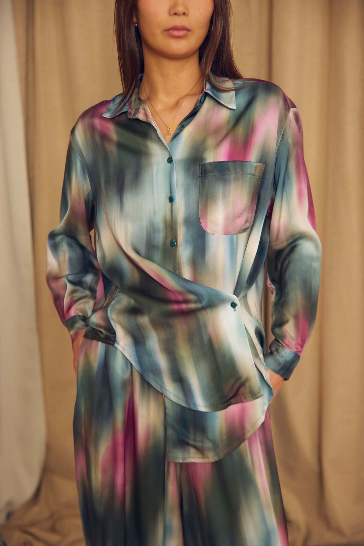 Model wearing a Printed ECOVERO Viscose Oversized Shirt in colorful pattern, showcasing its relaxed fit and elegant design.