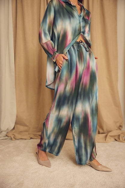Model wearing Printed ECOVERO Viscose Barrel-Leg Trousers with a colorful, fluid design in a stylish setting.