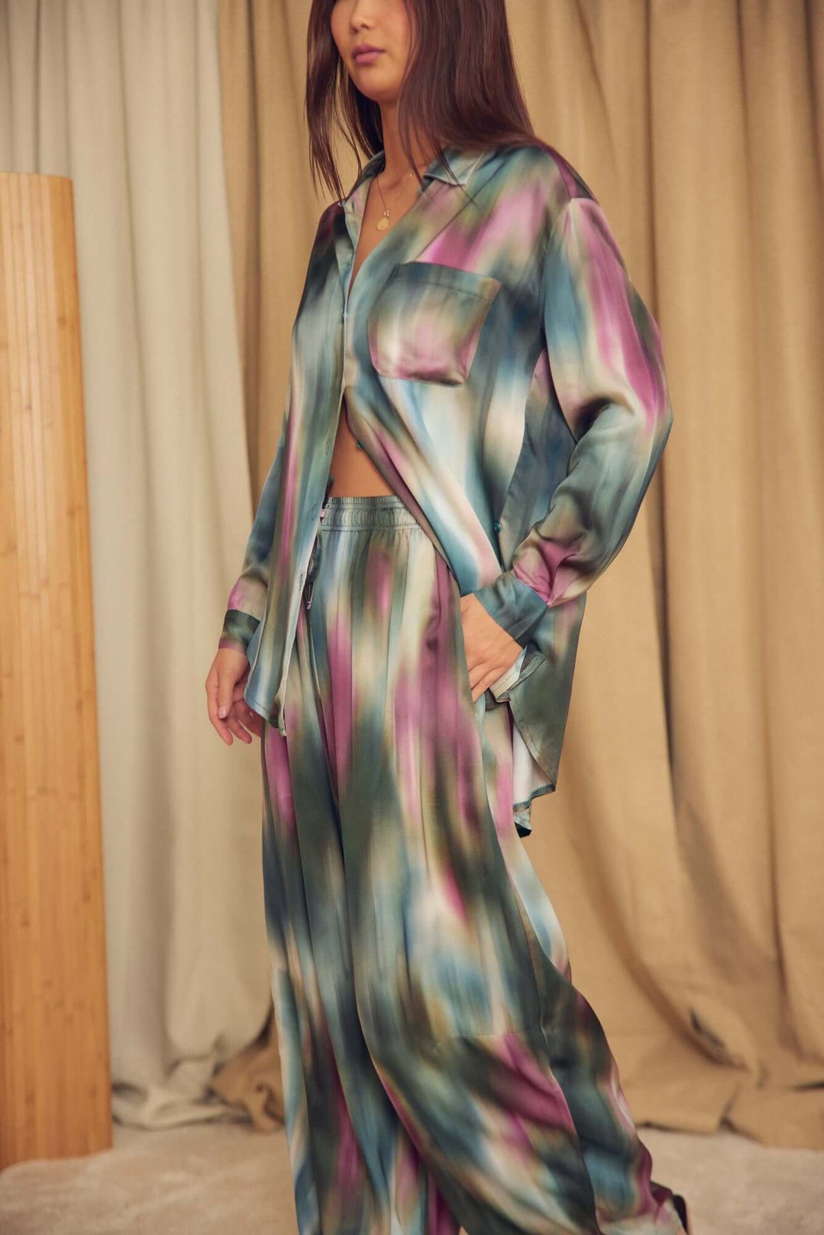 Model wearing a Printed ECOVERO Viscose Oversized Shirt, featuring a fluid oversized silhouette and vibrant color pattern.