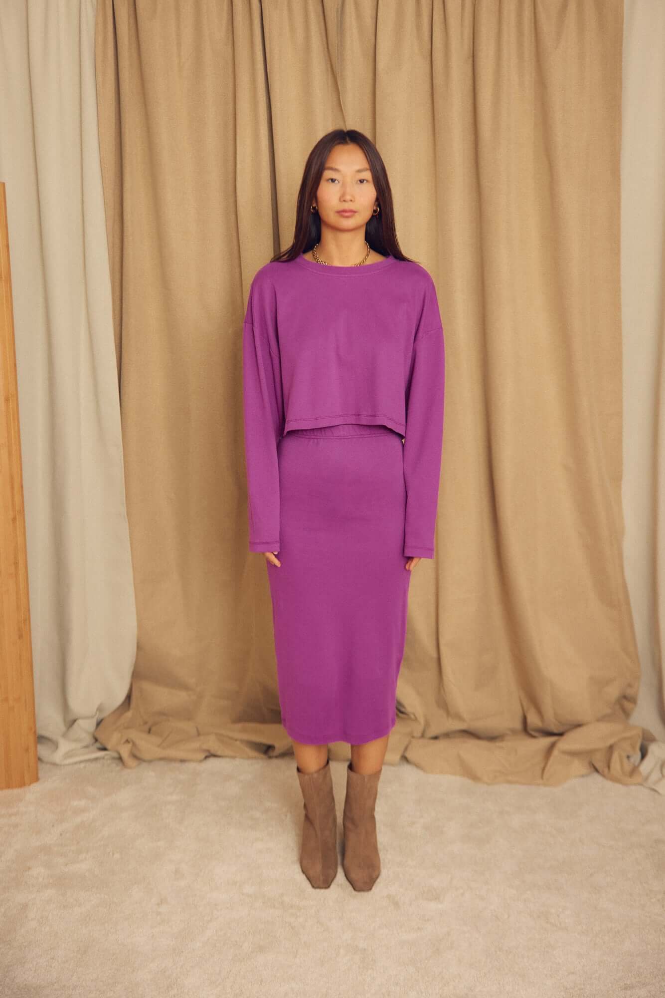 Model wearing a Plum Organic Cotton Oversized Crop Top with a matching skirt in a studio setting.