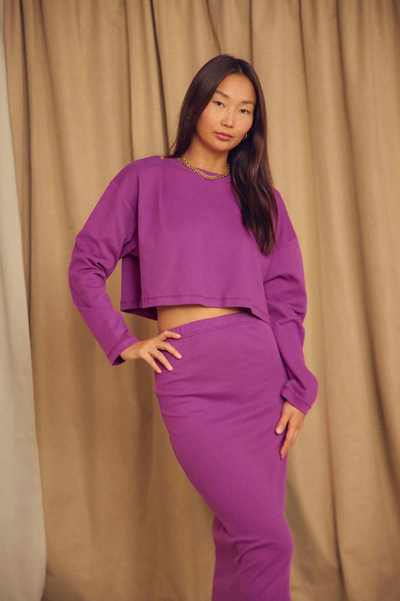 Model wearing a Plum Organic Cotton Pencil Midi Skirt with a matching cropped top, set against a neutral backdrop.