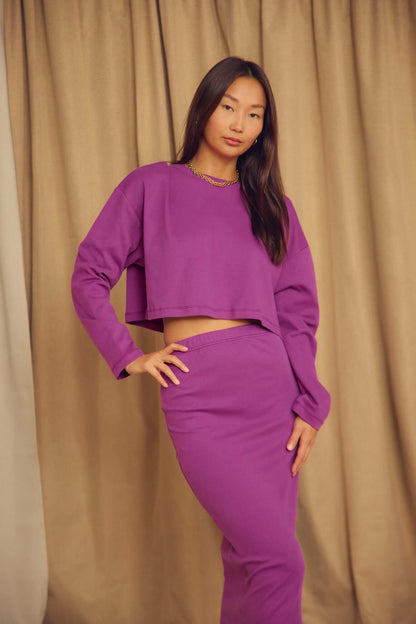Model wearing a Plum Organic Cotton Pencil Midi Skirt with a matching cropped top, set against a neutral backdrop.