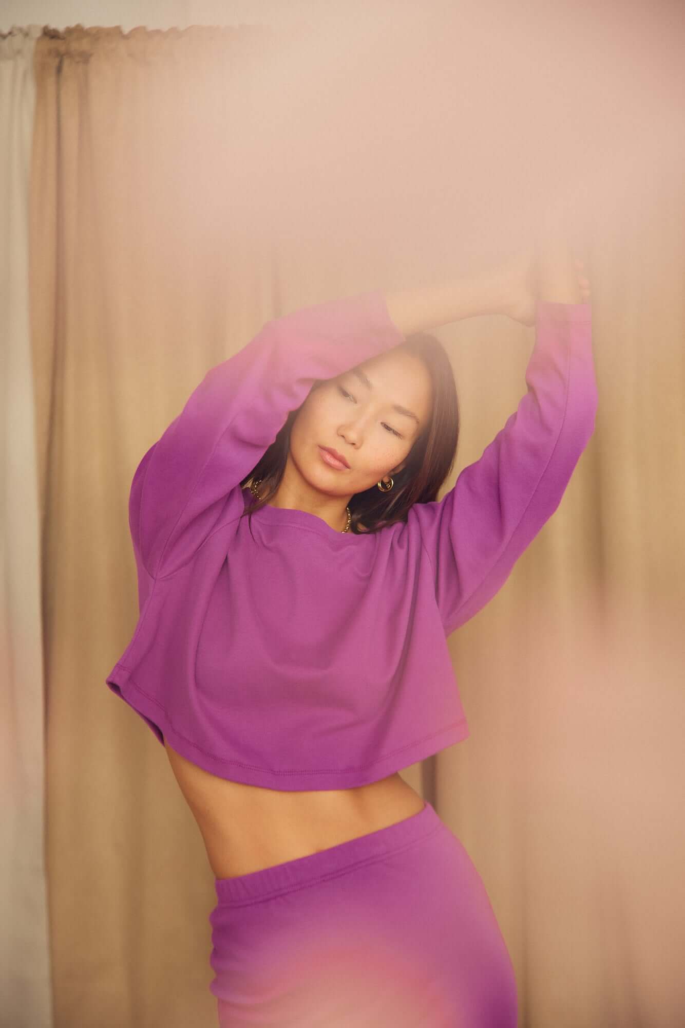 Model wearing Plum Organic Cotton Oversized Crop Top in purple, showcasing the relaxed, contemporary fit and style.
