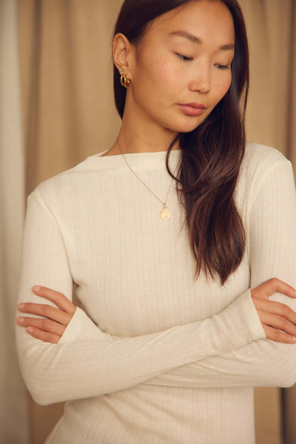 Ecru Lyocell Ribbed Long Sleeve Top worn by a woman with light brown hair, featuring a soft close-to-body fit.