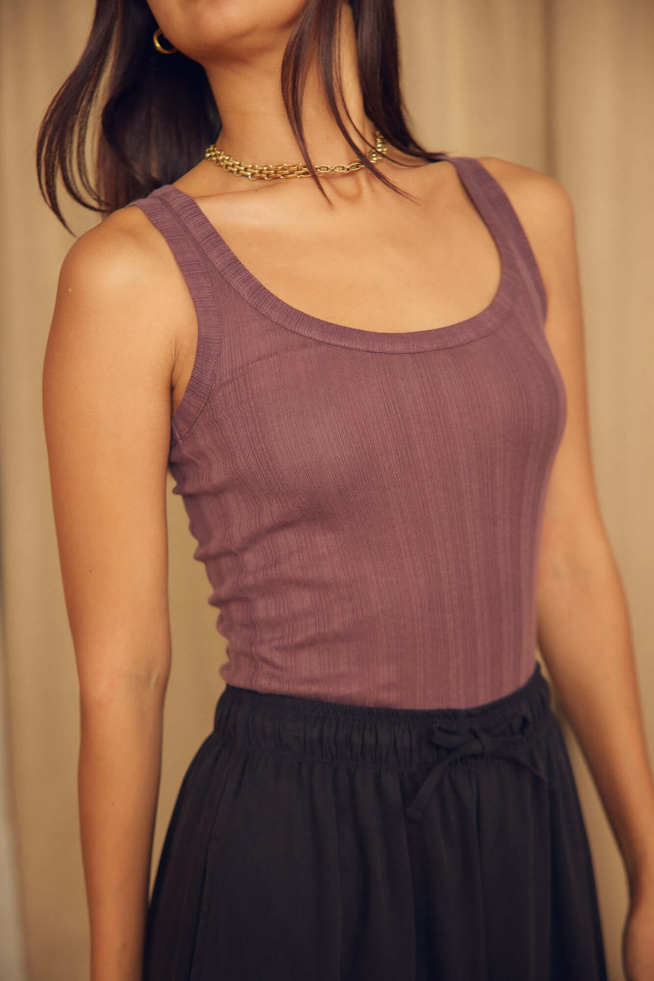 Cocoa Lyocell Ribbed Tank Top worn with black pants, showcasing a soft ribbed design in rich cocoa brown.