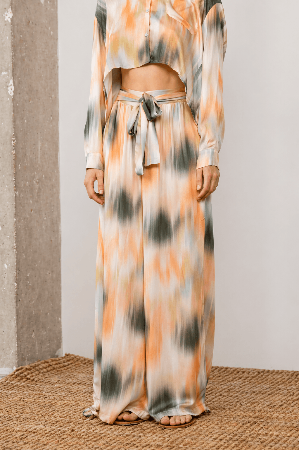 A model wearing Printed Ecovero Viscose Wide-Leg Trousers paired with a cropped top in a soft print, showcasing relaxed elegance.