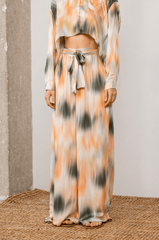 A model wearing Printed Ecovero Viscose Wide-Leg Trousers paired with a cropped top in a soft print, showcasing relaxed elegance.