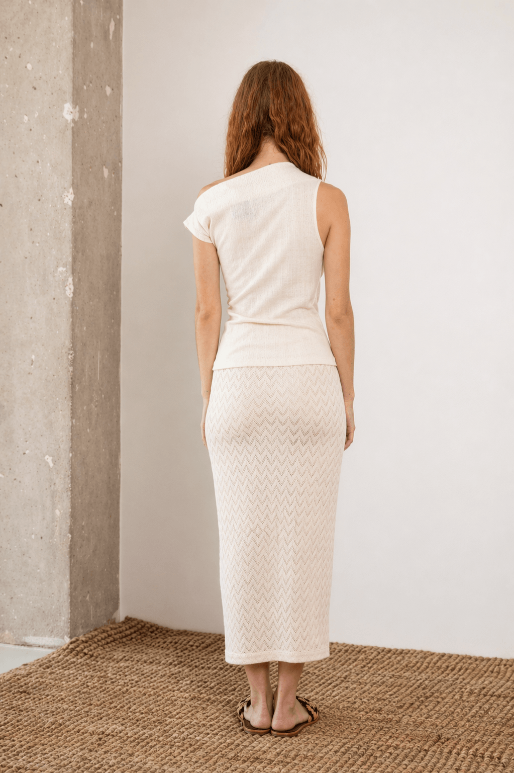 Woman wearing Banana Pineapple Drape Neckline Top in Ecru from the back, showcasing its elegant design.